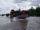 Line of Rice Boats Underway on the Mekong Delta