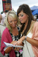 Two ladies study the form at Ayr racecourse