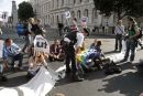 Democracy Villagers sit on the road
