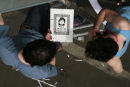 Graffiti artists examine stencil at The Cans Festival